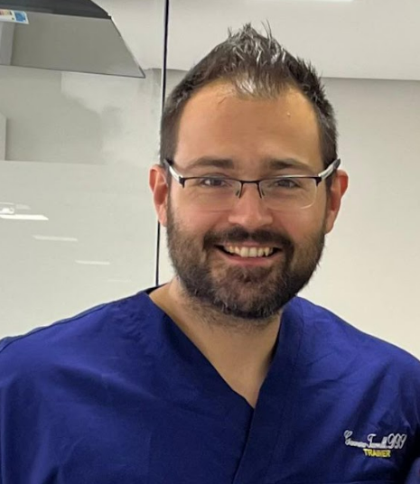 A portrait photo of Dr. Gianmarco Tacconelli, a specialist in implantology and maxillary rehabilitation.